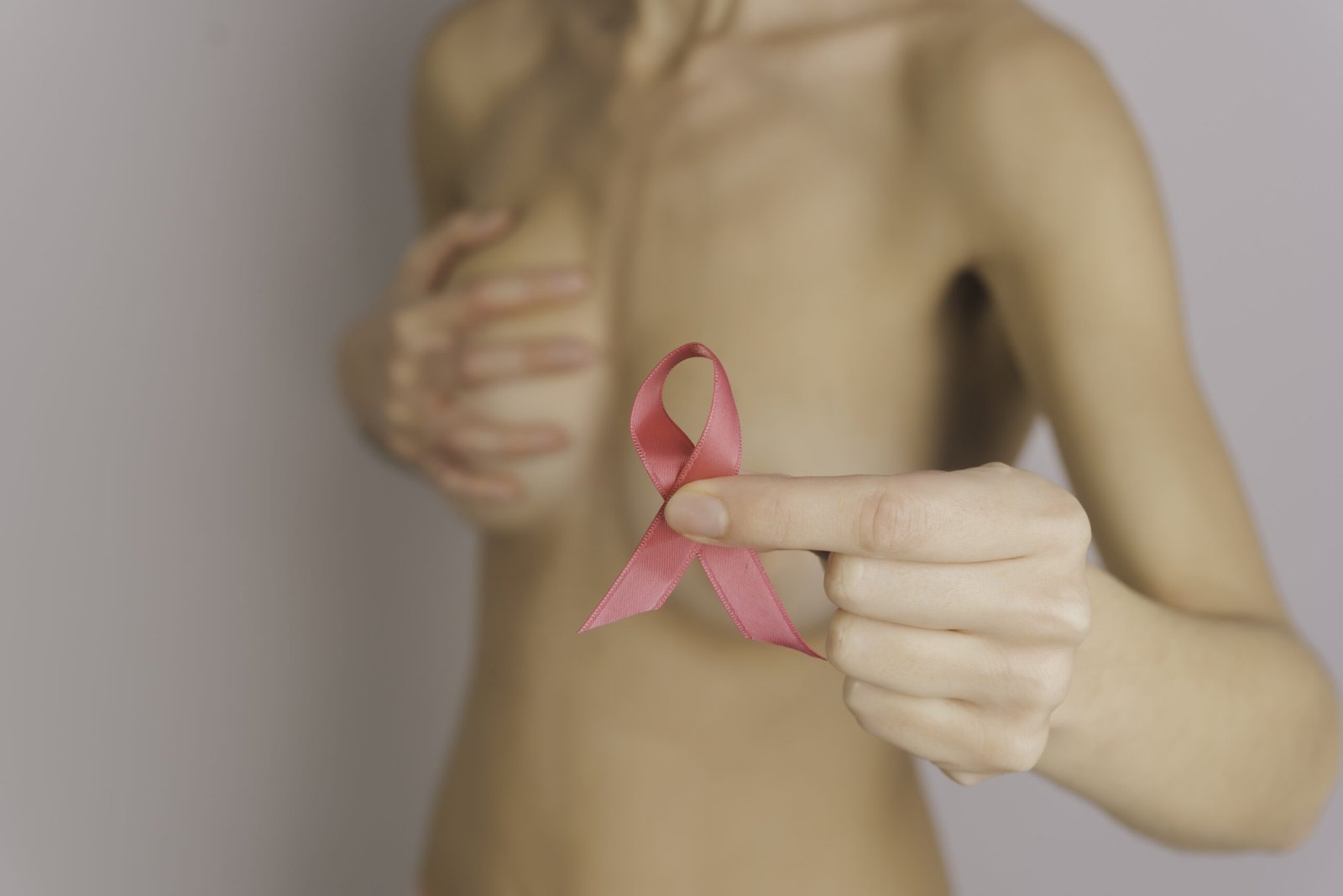 Woman holding a pink ribbon